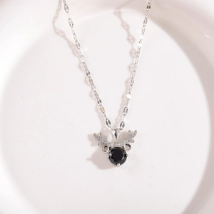 Detail of silver deer horn necklace featuring a black round stone and pavé accents