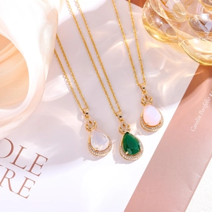 Gold-plated teardrop pendant necklace set with faux jade stones and crystals