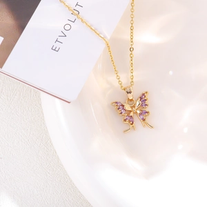 Detailed close-up of a golden butterfly pendant necklace with purple marquise zircon stones