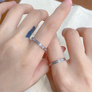 Pair of silver minimalist stainless steel rings with engraved lettering for couples
