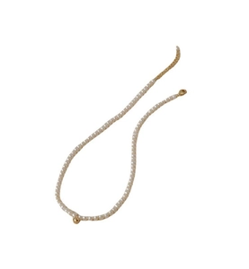 Detail of delicate pearl necklace featuring a central gold ball charm and adjustable clasp
