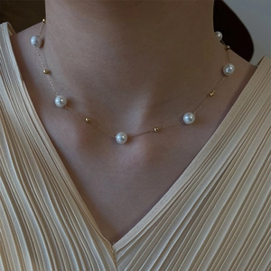 Elegant summer pearl necklace in titanium steel with delicate gold bead accents