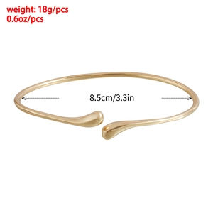 Polished gold open arm cuff bracelet with teardrop ends, 18g weight and 8.5cm diameter
