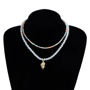 Detailed view of bohemian double-layered necklace with colorful beads and shell pendant