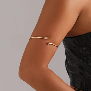 Minimalist gold arm cuff for women featuring adjustable open design and teardrop ends