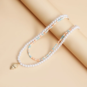 Detailed close-up of double layer necklace with shell pendant and colorful beads