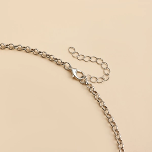 Detailed close-up of a silver lobster clasp and extension chain for a Y2K necklace