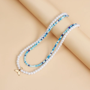 Close-up of bohemian double-layer necklace with blue seed beads and faux pearls