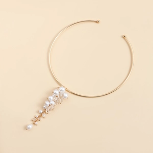 Detail view of gold choker necklace with elegant white pearls and crystal fringe dangles