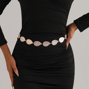 Elegant rose gold leaf metal chain belt accessory styled on a black pleated dress