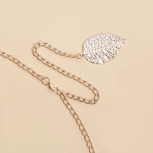 Detailed macro view of the hollow leaf buckle and polished rose gold chain links
