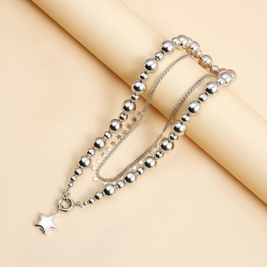 Detail view of silver layered star necklace with bead chain and polished star pendant