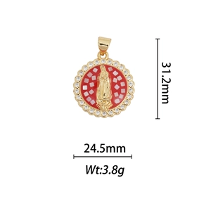Macro detail of gold-plated Virgin Mary pendant with red mosaic and zircon border