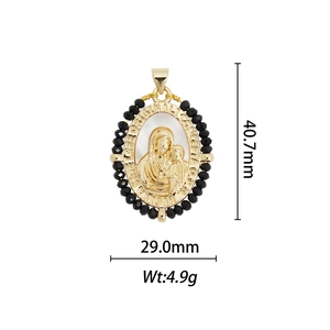 Macro detail of an 18k gold plated religious pendant with mother of pearl and black beads