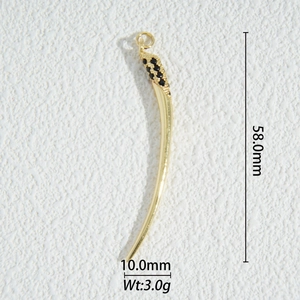 Macro shot of a 58mm gold tusk pendant with black pave stones for DIY jewelry making