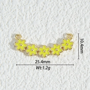 Detailed macro view of 18K gold-plated floral jewelry connector with yellow enamel