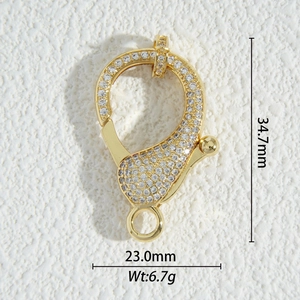 Macro shot of gold-plated lobster clasp with cubic zirconia pave for jewelry making