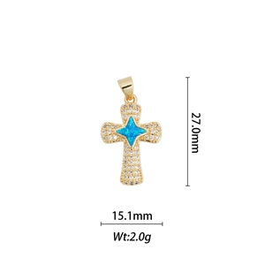 Dettaglio macro del ciondolo a croce placcato oro 18k con stella di opale e zirconi