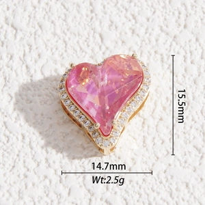 Macro shot of 15.5mm pink faceted crystal heart pendant with diamond halo and gold plating