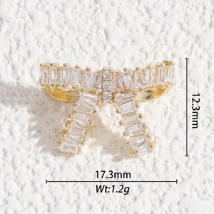 Detailed view of gold bow pendant with zircon dimensions 17.3mm width and 12.3mm height