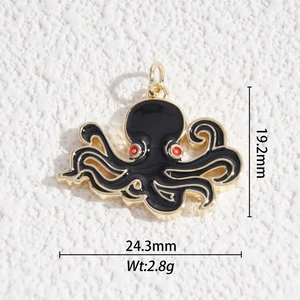 Gold octopus pendant with black enamel and red dot eyes on a white stone background