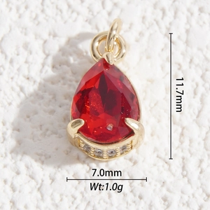 Macro detail of faceted red crystal waterdrop pendant with gold base and white zircons