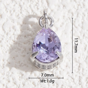 Macro shot of a purple teardrop crystal pendant showing dimensions 11.7mm by 7.0mm
