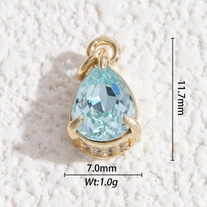 Macro detail of teardrop blue gemstone pendant with gold claws and pave-set accents