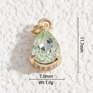Macro view of a 11.7mm pear-cut light green crystal pendant with gold prong setting