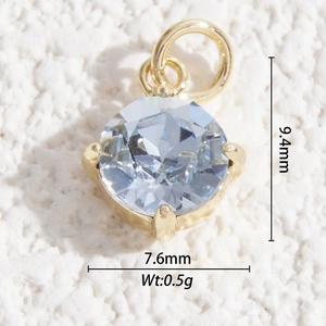 Close-up of faceted light blue crystal pendant with gold setting and size dimensions