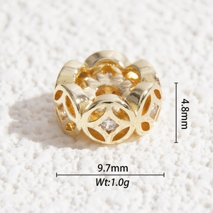 Macro view of gold-plated hollow bead with clear zircons, size 9.7mm by 4.8mm
