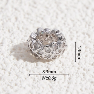 Macro detail of silver floral bead showing 4.3mm thickness and 8.3mm diameter dimensions