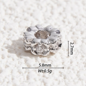 Macro shot showing 5.8mm floral 925 silver charm with cubic zirconia for DIY jewelry