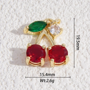 Detailed macro view showing red cherry charm dimensions and gold plated metal base