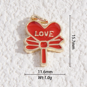 Macro shot of red heart lollipop charm with golden LOVE text and bow detail