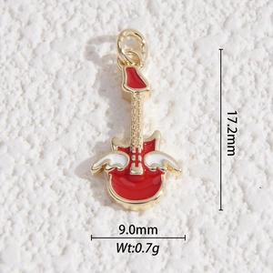 Macro view showing dimensions of a winged guitar pendant with red and white enamel