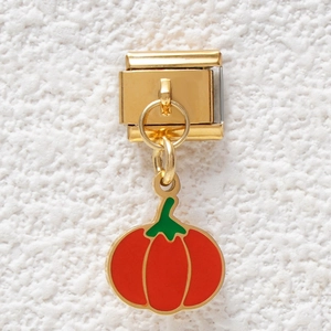 Detail of Italian modular bracelet link with orange pumpkin charm in gold stainless steel