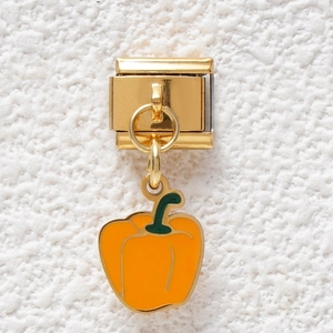 Detail of Italian charm bracelet link featuring orange capsicum pendant in gold finish