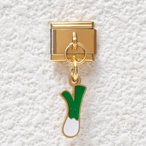 Detail of Italian charm link featuring a green scalloped onion pendant in gold finish