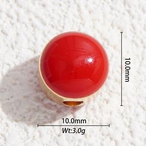 Macro detail of 10mm red enamel balloon pendant with gold base for DIY jewelry making