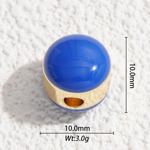 Macro shot of a 10mm blue enamel and gold-plated spherical charm bead for DIY jewelry