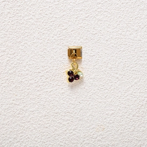 Detail of Italian charm pendant with purple and green crystals in gold finish