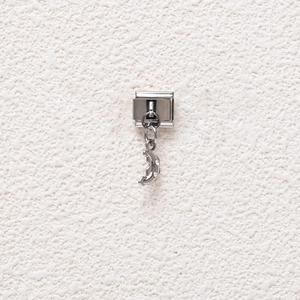 Detail of Italian modular stainless steel charm with a crescent moon pendant and zircons
