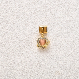 Macro detail of heart charm with pink cat eye stone and stars for modular bracelet