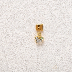 Detail of Italian charm with gold plating and green marquise gem with white rhinestones