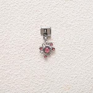 Detail shot of an Italian charm bracelet floral pendant with pink sparkling crystals