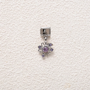 Detailed view of a floral charm module with purple crystals for DIY charm bracelets