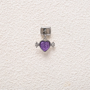 Macro view of heart-shaped wing charm with purple glitter for DIY bracelets