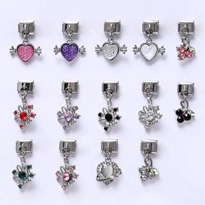Macro display of fourteen diverse Italian charms featuring wings hearts and vibrant gemstones