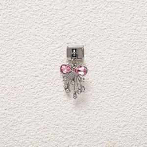 Close-up of pink gem bow charm on stainless steel modular bracelet with white cubic zirconia